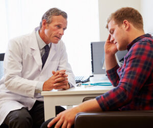 male doctor giving bad news to male patient